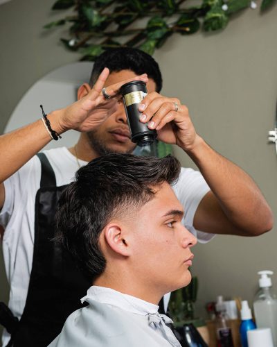 client-receiving-a-haircut-service-in-a-barbershop-ZPLAGXQ.jpg