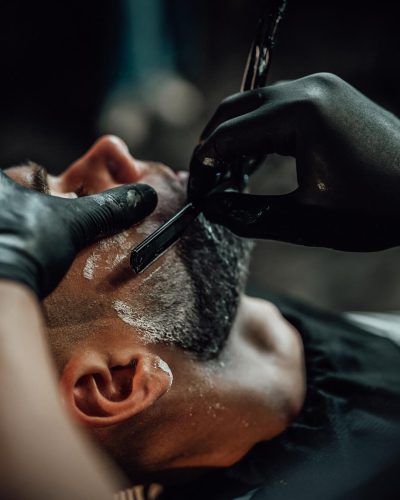 skillful-barber-shaving-a-customers-beard-in-saloo-ZTHRJSM.jpg